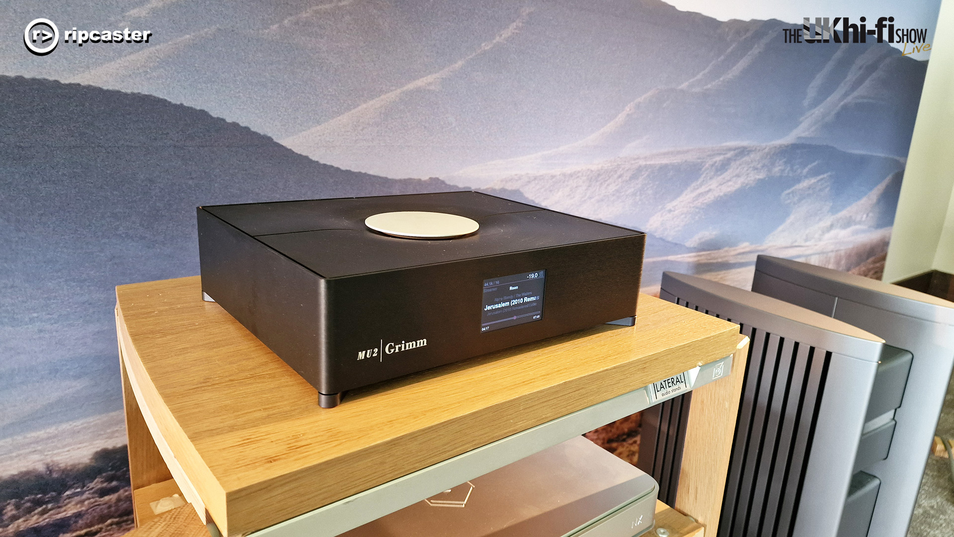 The Grimm Audio MU2 on a hifi stand with a landscape backdrop