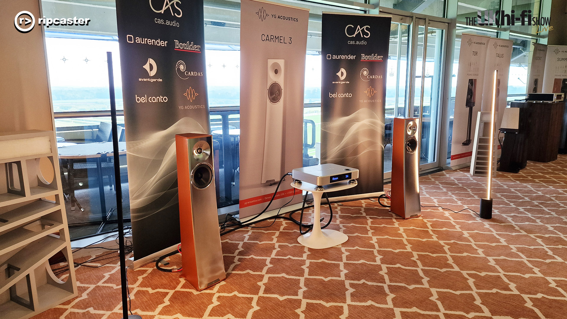 A pair of floorstanding speakers either side of a HiFi unit.  