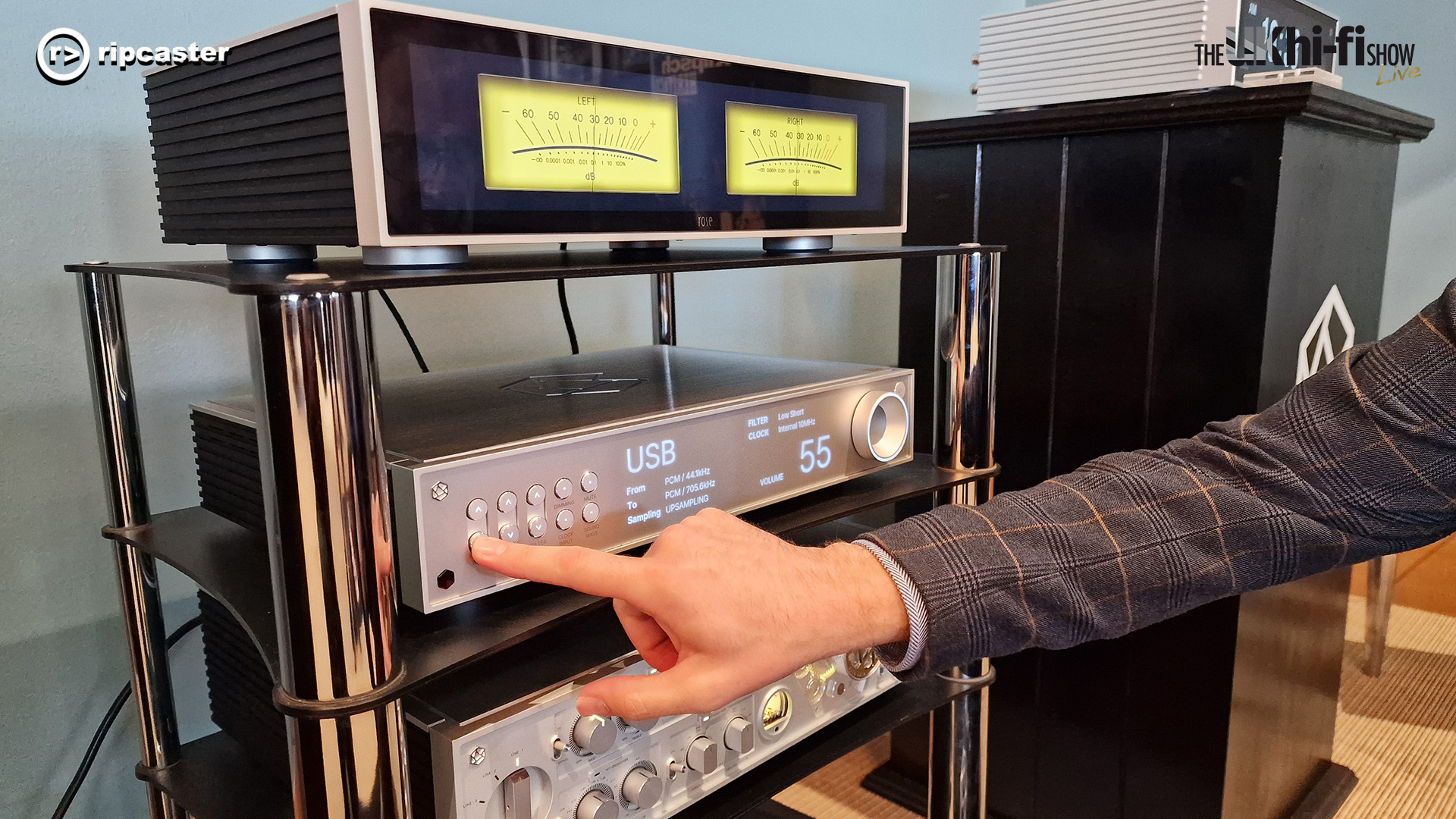 Three pieces of HiFi Rose equipment.  A man's hand is pressing one of the buttons.