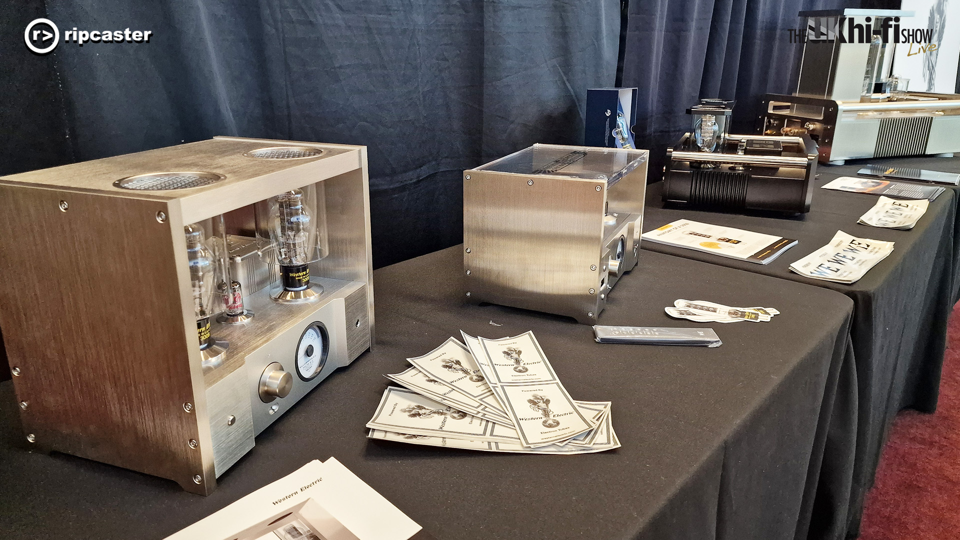 A selection of tube amplifiers on a table covered in a black cloth