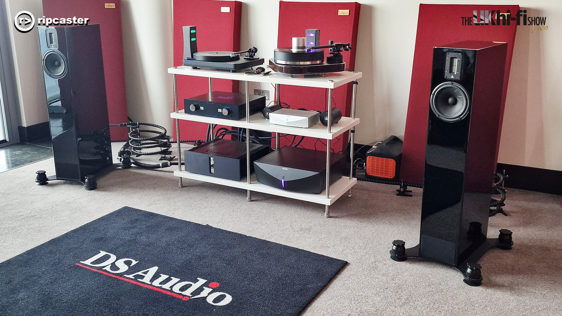 DS Audio.  A pair of floorstanding speakers with HiFi equipment on a rack between them.