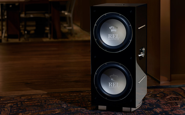 REL 212/SX Subwoofer on the floor of a wooden floor space 