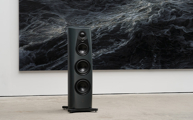 Linn 360 speaker in Triton in front of a large canvas of a very dark ocean