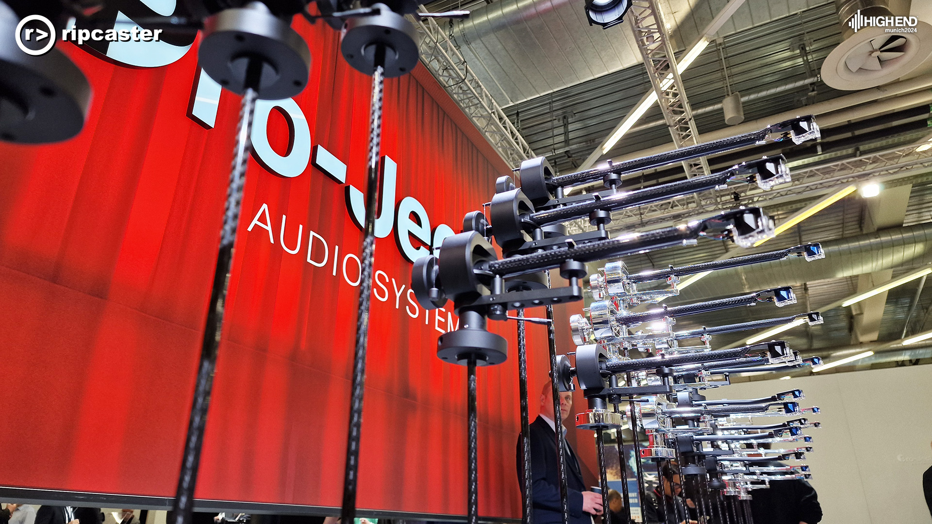 The tonearm arrangement taken from underneath with the red Project backdrop visible.