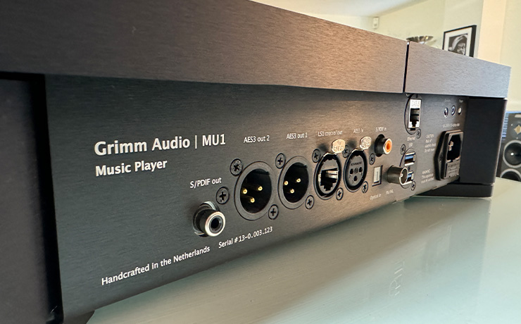 Grimm MU1 rear view with a speaker and picture partially visible in the background