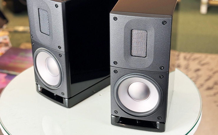 A pair of Raidho Acoustics X1t Loudspeakers on a white circular table