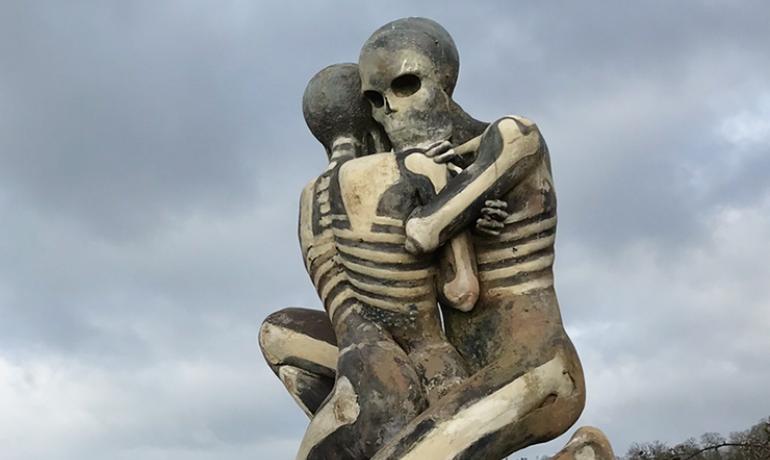 The Nuba sculpture which shows two people embracing.  The sculpture is grey with white painted bones.