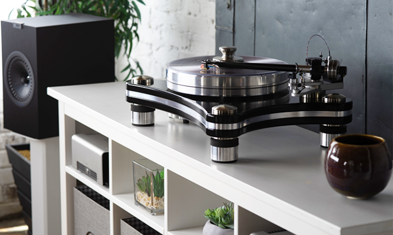 VPI Signature 21 on a white shelving unit with a speaker in the background