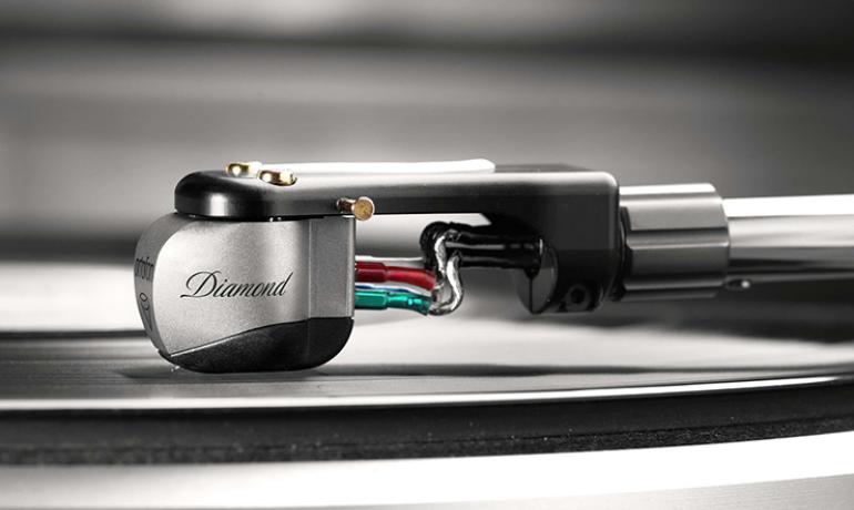 Ortofon MC Diamond Cartridge on a tonearm playing a record viewed from the side