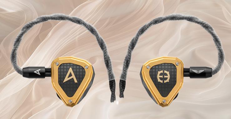 Astell & Kern Novus earphones.  The earbuds are black with a gold outline.  Background is of translucent fabric