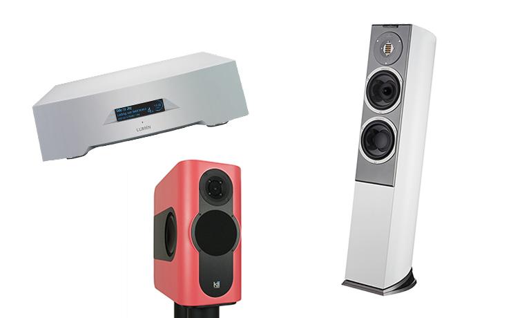 The Kii Three speaker in salmon, the Audiovector speaker in white and the Lumin in silver all on a white background