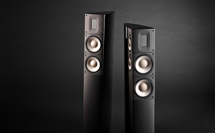 A pair of Raidho X2 speakers on a very dark background
