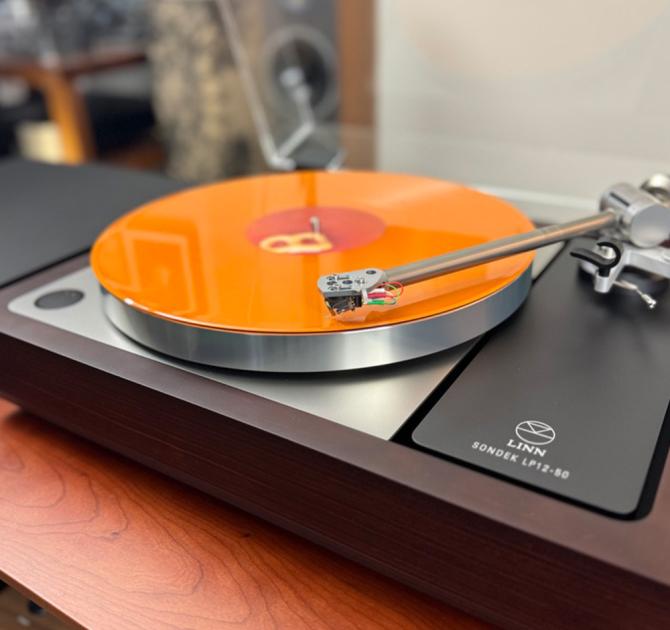 Linn Sondek LP12-50 Turntable with an orange record playing on it