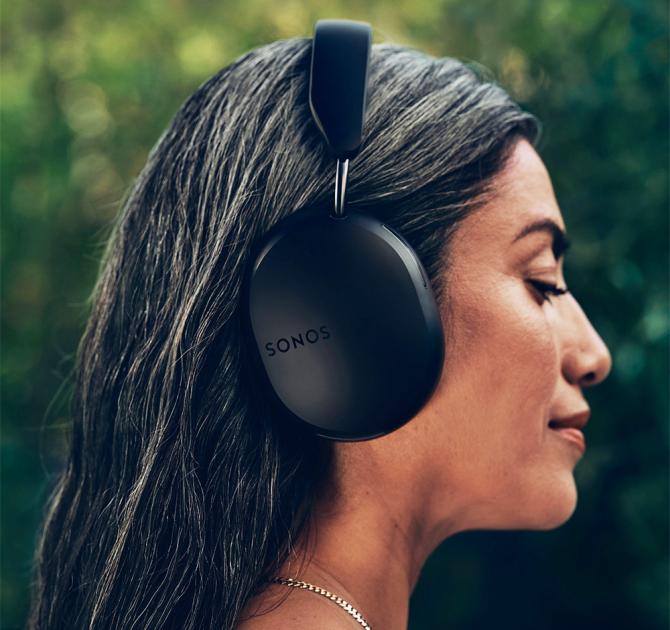 Sonos Ace Headphones in black on the head of a woman