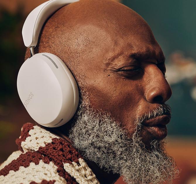 Sonos Ace Headphones in white on the head of a man