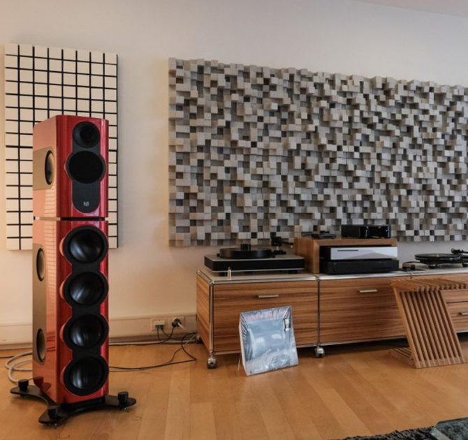 Kii Three BXT System in red in a living room setting with a side unit with two turntables.