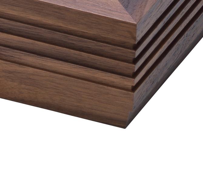The corner of a Linn LP12 Fluted Plinth turntable in Walnut
