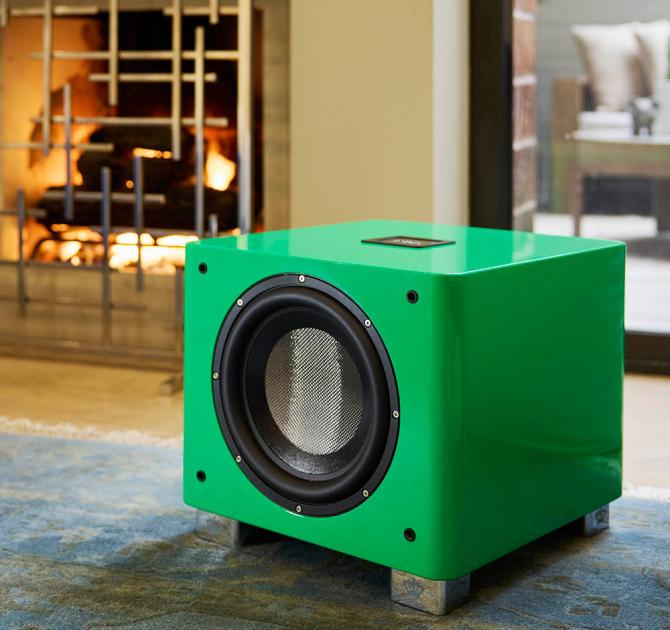 The REL T9x special edition in green beside a fireplace