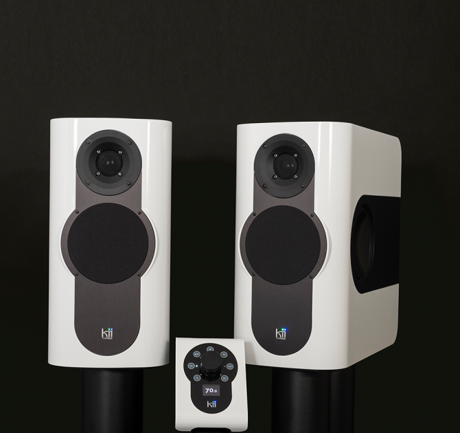 A pair of Kii Three Loudspeakers in gloss white with matching Kii Controller