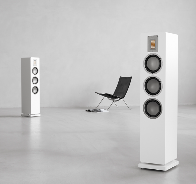 Audiovector QR5 pair in white with a chair.