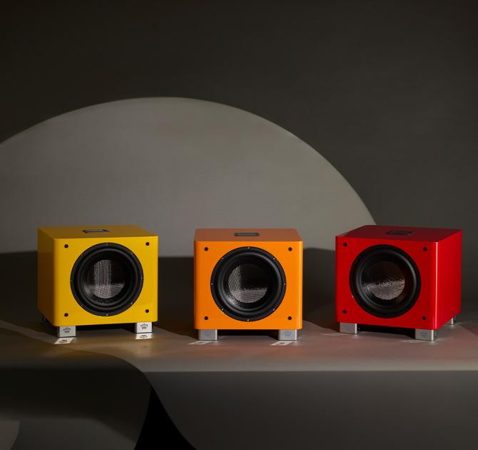 Three REL T/9x Special Edition Subwoofers - one red, one orange and one yellow