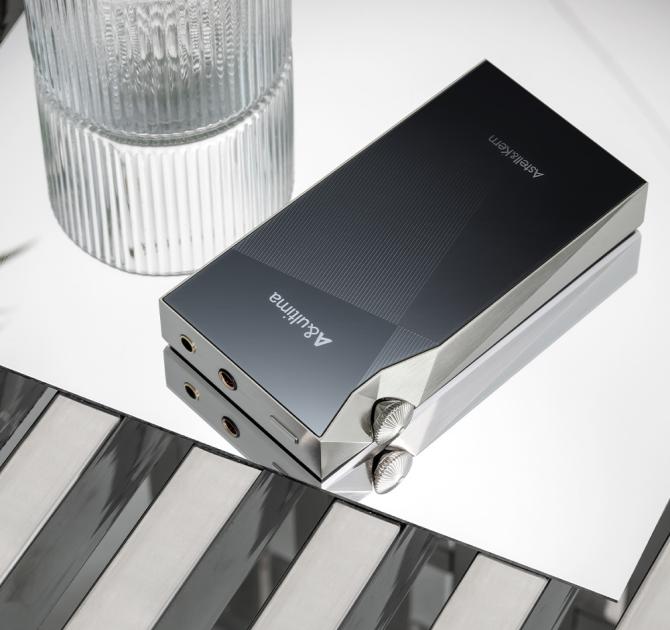 A&K SP3000M in copper nickel laying face-down beside a glass of water