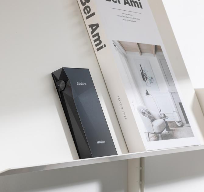 Astell & Kern A&ultima SP3000M Portable Music Player beside a book