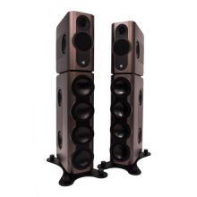 A pair of tall Kii speakers in a bronze colour