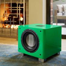 The REL T9x special edition in green beside a fireplace