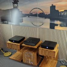 A pair of black Klimax Solo 500 amplifiers either side of a black Klimax DSM.