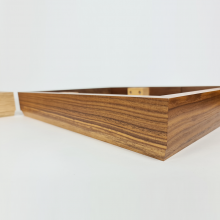Close-up side view of the walnut plinth with a little bit of oak visible next to it.