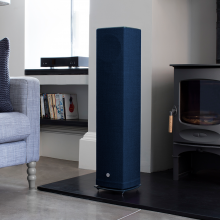 Linn Akurate DSM in a living room next to a blue, Series 5 speaker.