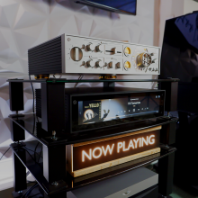 HiFi Rose RA180 on the top shelf of a HiFi stand.  Below is the rose RS150 streamer.  Below that is our 'Now Playing' sign.