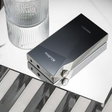 A&K SP3000M in copper nickel laying face-down beside a glass of water
