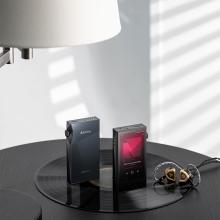 A pair of Astell & Kern A&ultima SP3000M Portable Music Players standing up ona  table