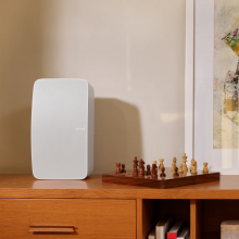 SONOS Five in white on a cabinet with a chess set beside it.