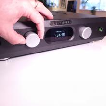 Ultrafide U4PRE Audiophile Pre-Amplifier front view with a hand on the control